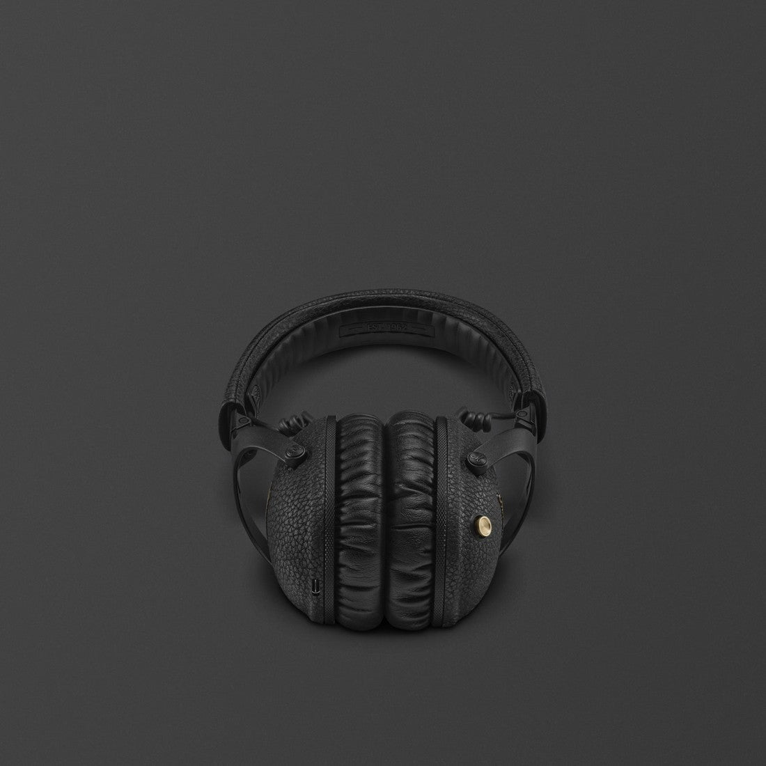 Marshall Monitor III A.N.C. Black over-ear bluetooth headphones featuring a small gold accent on one side, displayed against a dark background.