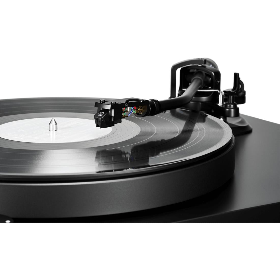 Tonearm of the Audio-Technica AT-LP8X turntable lifting off of a record