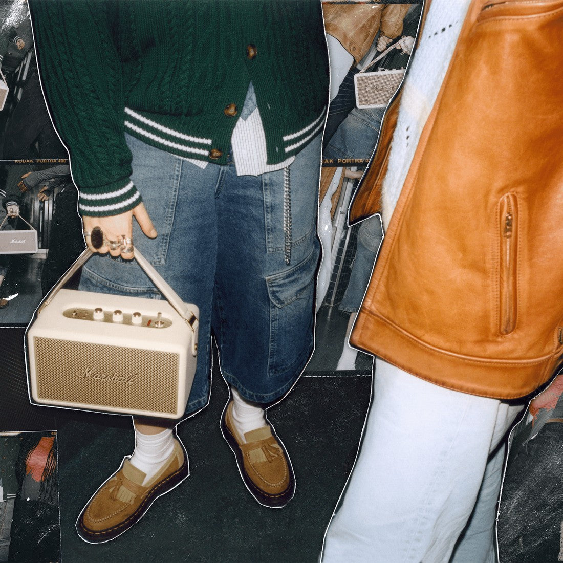 A person holds the Marshall Kilburn III Cream portable speaker.