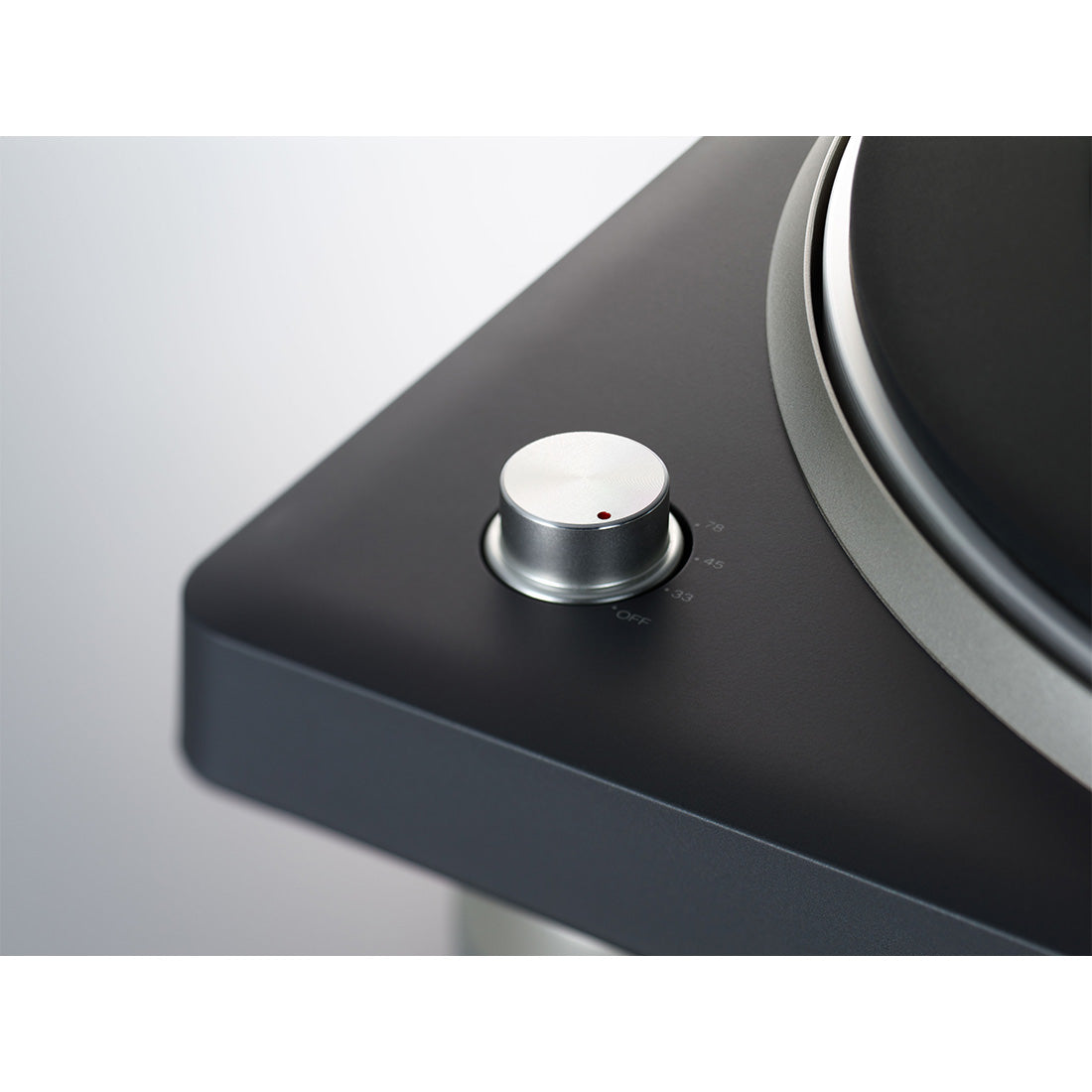Close-up of a turntable with a focus on the platter and tonearm.