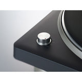 Close-up of a turntable with a focus on the platter and tonearm.