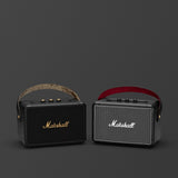Two portable Marshall KILBURN II Bluetooth speakers on a grey background.