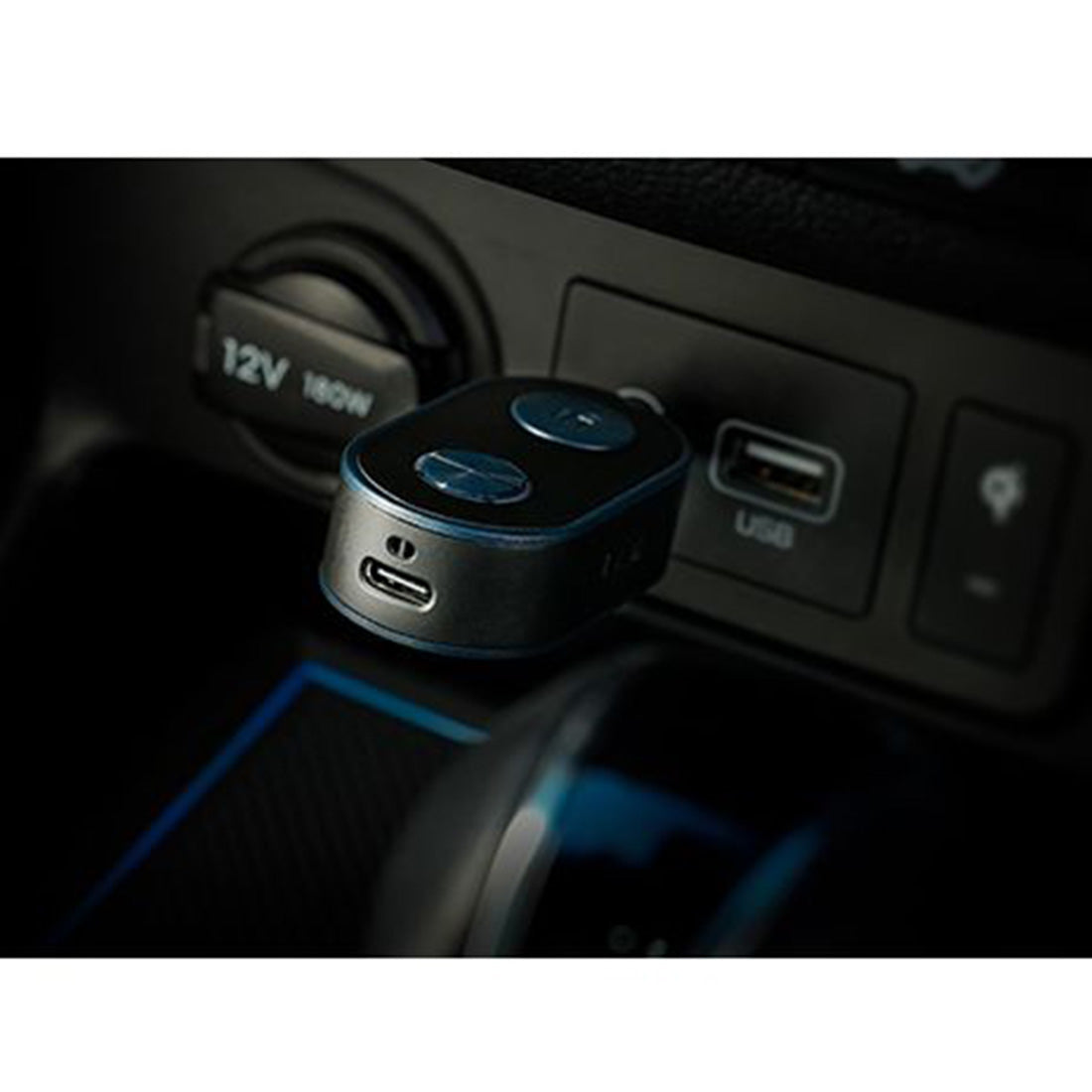 Car charger adapter with USB ports on a car dashboard