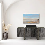 Modern interior with a television displaying a beach scene, a decorative vase, and a console table.