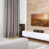 Modern living room with a TV, speakers, and a sofa.