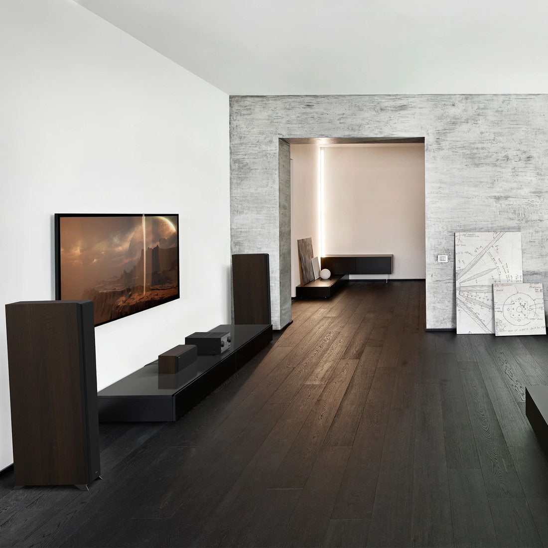 Modern living room with a television, speakers, and decorative elements.